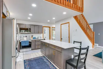 a kitchen with a table and a chair in it at Lakefront Poconos Cabin with Deck and Game Room in Pocono Lake