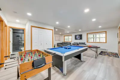 a living room with a ping pong table at Lakefront Poconos Cabin with Deck and Game Room in Pocono Lake