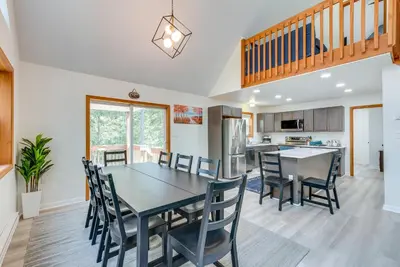 a kitchen and dining room with a table and chairs at Lakefront Poconos Cabin with Deck and Game Room in Pocono Lake