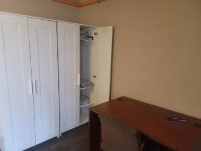 a room with a white closet and a desk at CareHouse Residence in Lawnside