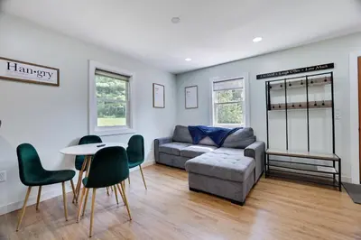 a living room with a couch and a table and chairs at Cozy 2 Bedroom apartment in Tannersville, minutes from Camelback Mountain in Tannersville