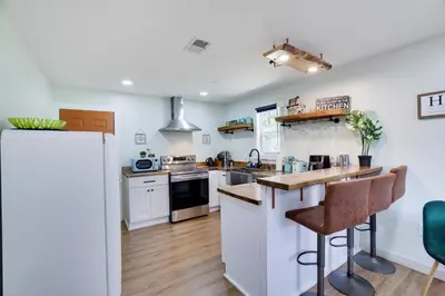 a kitchen with white appliances and wooden floors at Cozy 2 Bedroom apartment in Tannersville, minutes from Camelback Mountain in Tannersville
