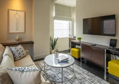 a living room with a couch and a table at Charming 2BR Apartment Near Times Square in New York