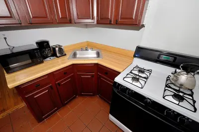 a kitchen with a stove and a sink at Midtown West Furnished 3 Bedroom Apartment in New York
