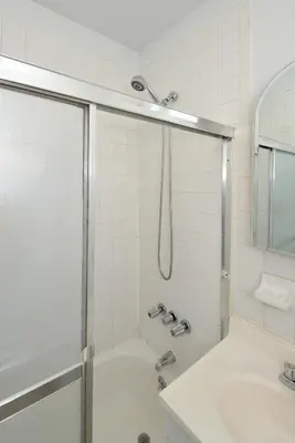 a bathroom with a shower and a sink at Midtown West Furnished 3 Bedroom Apartment in New York