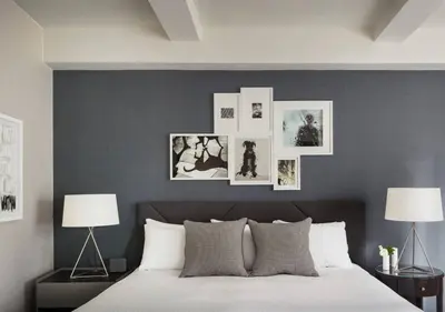 a bedroom with a bed with pictures on the wall at 3BR Apartment in Big Apple in New York