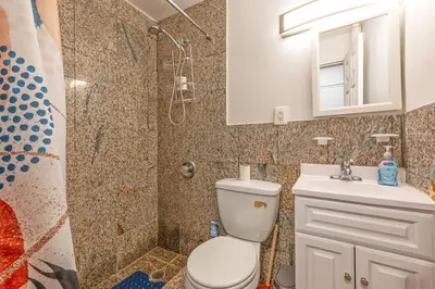 a bathroom with a toilet and a shower and a sink at Amazing Studio in Kips Bay in New York