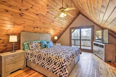 a bedroom with a bed and a wooden ceiling at The Log Cabin Near Elk Mountain Ski Slopes in Pleasant Mount