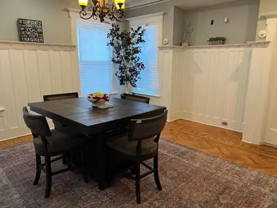 a dining room with a black table and chairs at The Grand Parkway is a unique getaway with charm! in East Orange