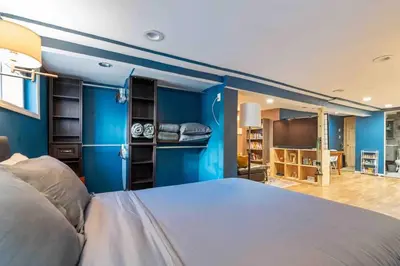 a bedroom with blue walls and a large bed at The Hygge Way, 20MIN TO NYC Times Sq in North Bergen