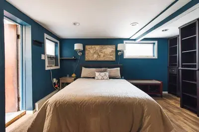 a bedroom with a large bed with blue walls at The Hygge Way, 20MIN TO NYC Times Sq in North Bergen