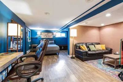 a living room with a bed and a couch at The Hygge Way, 20MIN TO NYC Times Sq in North Bergen