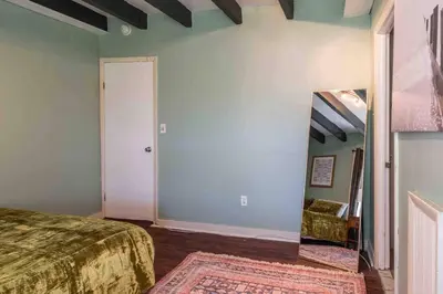 a room with a bed and a mirror and a door at 1918 Duplex with Character City Center in Philadelphia