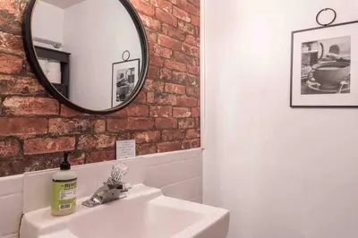 a bathroom with a sink and a mirror at 1918 Duplex with Character City Center in Philadelphia
