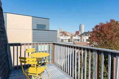 a table and two chairs sitting on a balcony at 1918 Duplex with Character City Center in Philadelphia