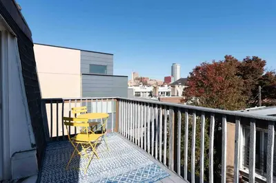 a yellow chair sitting on the balcony of a house at 1918 Duplex with Character City Center in Philadelphia