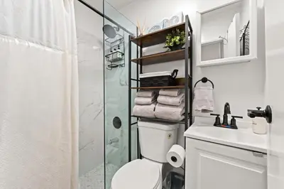 a bathroom with a shower and a toilet and a sink at Micro Studio Walk to Time Square in New York