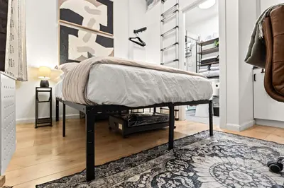 a bed in a room with a rug at Micro Studio Walk to Time Square in New York