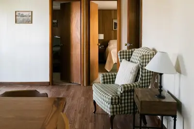 a living room with a couch and a chair and a table at Beaver Creek Cabin 1 in Strasburg