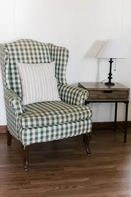 a green and white plaid chair sitting next to a desk at Beaver Creek Cabin 1 in Strasburg