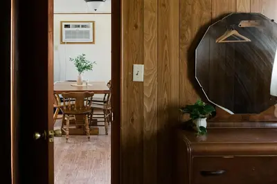a room with a table and a mirror on a door at Beaver Creek Cabin 1 in Strasburg