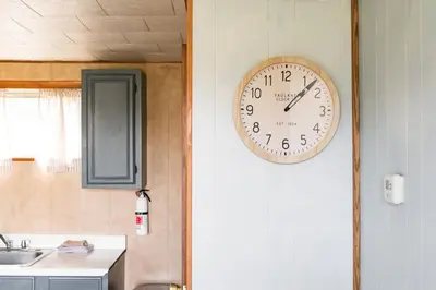 a clock on the wall of a kitchen at Beaver Creek Cabin 5 in Strasburg