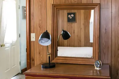 a lamp sitting on a table in front of a mirror at Beaver Creek Cabin 6 in Strasburg