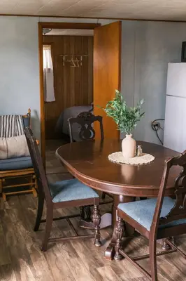 a dining room with a table and chairs and a couch at Beaver Creek Cabin 6 in Strasburg