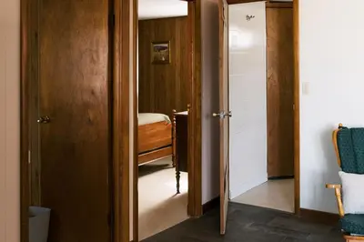a hallway with a door open to a room with a bed at Beaver Creek Cabin 2 in Strasburg
