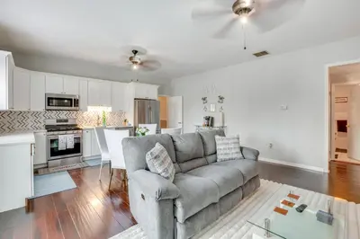 a living room with a couch and a kitchen at 5 Mi to Rutgers University New Jersey Guest Suite in South River