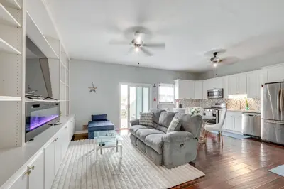 a living room with a couch and a kitchen at 5 Mi to Rutgers University New Jersey Guest Suite in South River