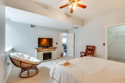 a bedroom with a bed and a tv and a chair at 5 Mi to Rutgers University New Jersey Guest Suite in South River
