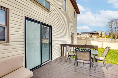 a patio with a table and chairs on a deck at 5 Mi to Rutgers University New Jersey Guest Suite in South River
