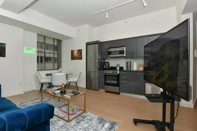 a living room with a large flat screen tv at The Wolf of Wall Street Apartment in New York