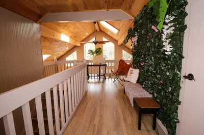 a room with a staircase with a plant at Villa MiaNova A Modern Hideout in the Woods in Lake Ariel