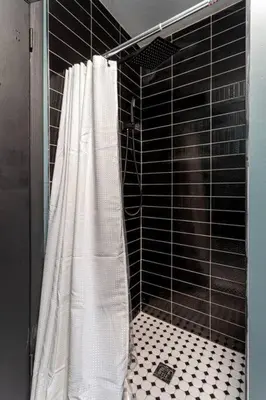 a shower with a white shower curtain in a bathroom at Water Front Dream Hot Tub Fire Pit King Bed in Tobyhanna