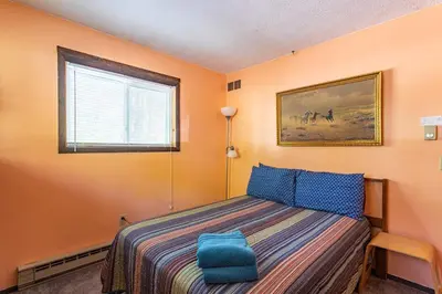 a bedroom with a bed and a window at Boardwalk Chalet Lakefront Fire Pit Pet Frie in Tobyhanna
