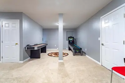 an empty room with a game room with a table and a video gameuminati at Hot Tub Game Room Fenced Yard Dog Friendly in Albrightsville