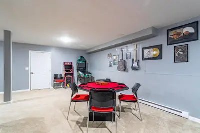 a dining room with a red table and chairs at Hot Tub Game Room Fenced Yard Dog Friendly in Albrightsville