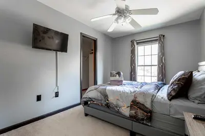 a bedroom with a bed and a ceiling fan at Hot Tub Game Room Fenced Yard Dog Friendly in Albrightsville