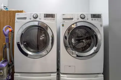 two washing machines are stacked next to each other at Hot Tub Game Room Fenced Yard Dog Friendly in Albrightsville