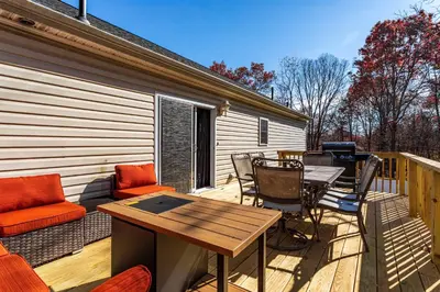 a deck with a table and chairs and a grill at Hot Tub Game Room Fenced Yard Dog Friendly in Albrightsville