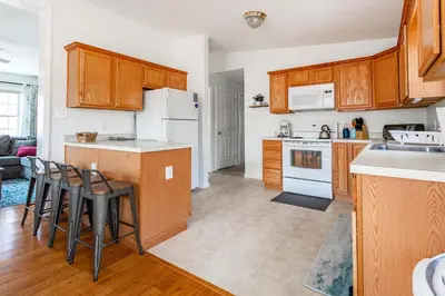 a kitchen with white appliances and wooden cabinets at My Blue Haven Game Area 4 BDR Pet Friendly in Albrightsville