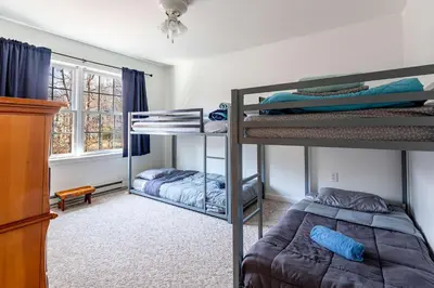 a bedroom with two bunk beds and a window at My Blue Haven Game Area 4 BDR Pet Friendly in Albrightsville