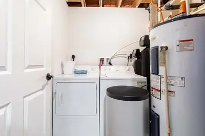 a kitchen with a refrigerator and a washer and dryer at My Blue Haven Game Area 4 BDR Pet Friendly in Albrightsville