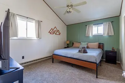 a bedroom with a bed and a ceiling fan at Game Room Fire Pit Dog Friendly in Tobyhanna