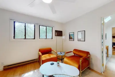 a living room with two chairs and a table at Sage Grove Sanctuary 3BD Hot Tub Fire Pit in East Stroudsburg
