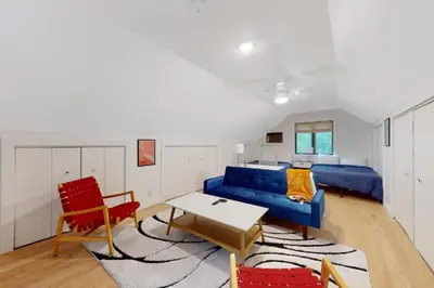a living room with a blue couch and red chairs at Sage Grove Sanctuary 3BD Hot Tub Fire Pit in East Stroudsburg