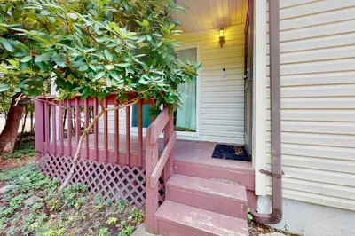 a house with a pink fence on the front door at Sage Grove Sanctuary 3BD Hot Tub Fire Pit in East Stroudsburg