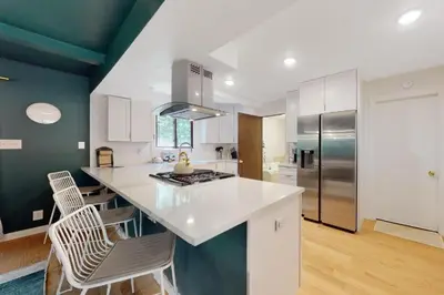 a kitchen with a white counter and a refrigerator at Sage Grove Sanctuary 3BD Hot Tub Fire Pit in East Stroudsburg